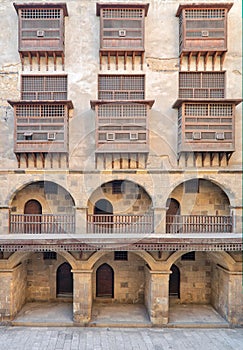 Facade of caravansary of Bazaraa, with vaulted arcades and windows covered by interleaved wooden grids mashrabiyya, Cairo, Egypt