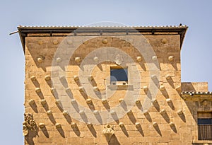 Facade of the Casa de las Conchas in Salamanca, Spain. exterior image shot from public floor