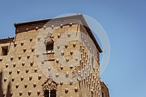 Facade of the Casa de las Conchas in Salamanca, Spain. exterior image shot from public floor