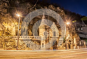 Facade of the Cave Church with lens flares located inside Gellert Hill in Budapest