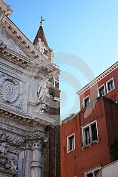 Facade of church and house in Venice photo