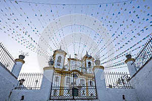 facade of church of Our Lady of Conception decorated with flags for festivities. Ouro Preto, Minas Gerais, Brazil