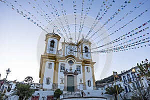 facade of church of Our Lady of Conception decorated with flags for festivities. Ouro Preto, Minas Gerais, Brazil