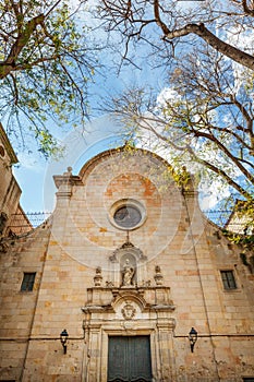 Facade of the church and Placa de Sant Felip Neri in Barcelona photo