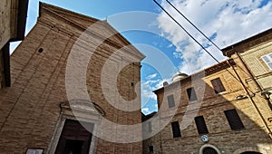 facade of a church and small square of an ancient italian medioeval village