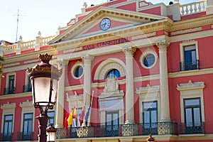 Facade of the city hall of murcia with clock and columns