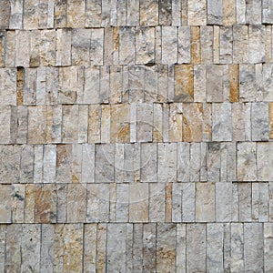 Facade cladding or wall finishing of pale ocher stone, building