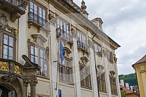 Facade of a classic building of Prague, Czech Republic, with an european flag