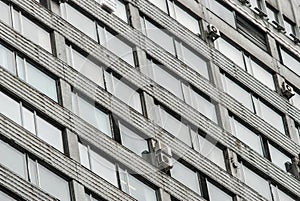 Facade of a Communist style concrete building, many windows and few air conditioners