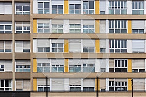 Facade of constructivist house with windows in the style of seventies with yellow panels