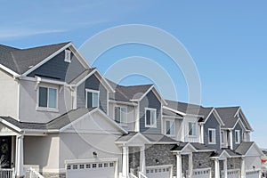 Facade of contemporary houses on a scenic suburban neighborhood landscape