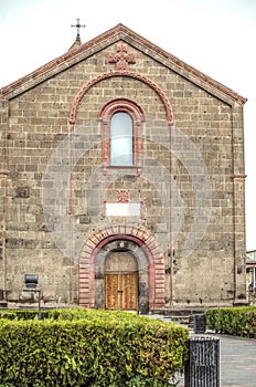 Facade with decorative patterned arches and openwork cross under the roof of the Church of St. Mesrop Mashtots in the village of O