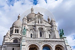facade and domes of landmark basilica in paris
