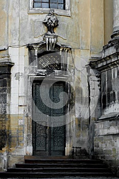 Facade of the Dominican Cathedral, Lviv, Ukraine. Fragment with door and window metal grill.