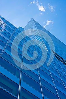 Facade of downtown office building with white clouds..