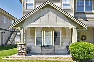 Facade of family house with casted bench at the window beside the entrance