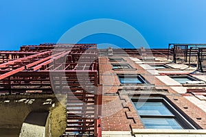 Facade and fire escape of pre-war walkup apartment building