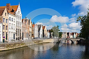 Facade of flemish houses and canal in Brugge