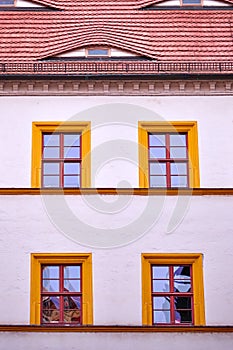 Facade with four orange framed windows