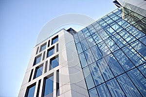 Facade fragment of a modern office building. Exterior of glass wall with abstract texture.