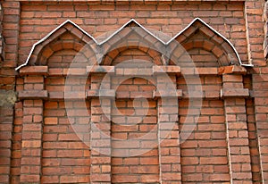 Facade front of an old factory building made of red brick with a lot of vintage windows