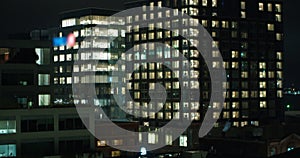 Facade of a glass office building at night.