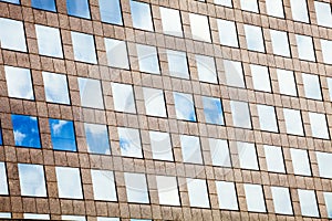 Facade glass windows with sky reflected. Modern office building.