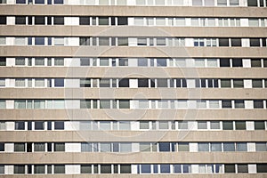 facade with granite cladding and a multitude of similar windows, some with curtains and others without