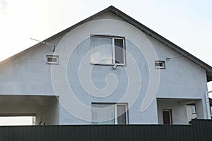 Facade of a gray private concrete house with windows