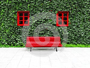 Facade with green vertical garden and red windows in a sustainable building