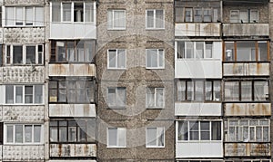 Facade of a grey multi-storey soviet panel building