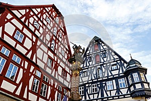 Facade of a half-timbered house and statue of St George and the dragon in Rothenburg ob der Tauber in Germany