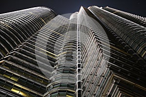 Facade of a highscraper seen during the night from down