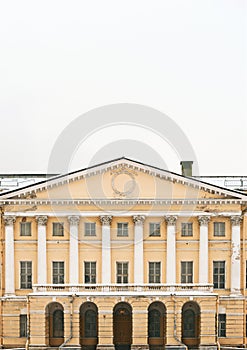 The facade of a historic building. Columns, capitals and high doors