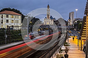 Facade of the historic building headquarters of Luz train Station and the Portuguese Language Museum, with the movement of trains