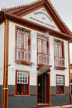 Facade of an historic building in the historical town of Serro, Minas Gerais Brazil, inscription translation: god, honor and work
