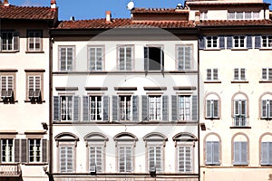 Facade of historical italian city, Tuscany. Windows with shutters of old houses in Italy