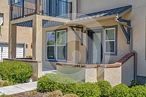 Facade of home with pathway that leads to the porch and glass paned front door