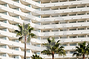 Facade  hotel or apartment building palm trees