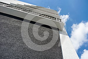 Facade of the house under construction with multi-colored decorative plaster