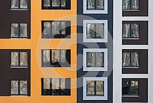 Facade of the house under construction with multi-colored decorative plaster