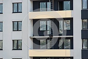 Facade of the house under construction with multi-colored decorative plaster