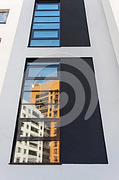 Facade of the house under construction with multi-colored decorative plaster