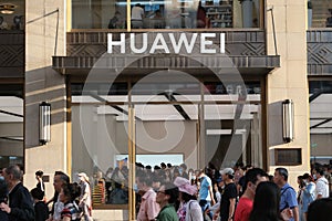 Facade of HUAWEI flagship store with crowd of people