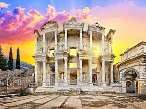 Facade of library of Celsus in Ephesus under yellow dramatic sky