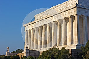 Facade of Lincoln Memorial in the morning against a clear blue sky.