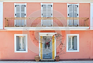 Facade of a lovely greek house with flowers and balcony