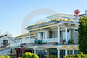 Facade of luxury residential house faced to a bay waterfront.