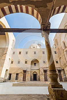 Main courtyard of Mamluk era public historic mosque of Sultan Qalawun framed by stone arch, Moez Street, Cairo, Egypt photo