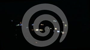 Facade with many windows, exterior of a modern apartment block at night, close up, shallow depth of the field